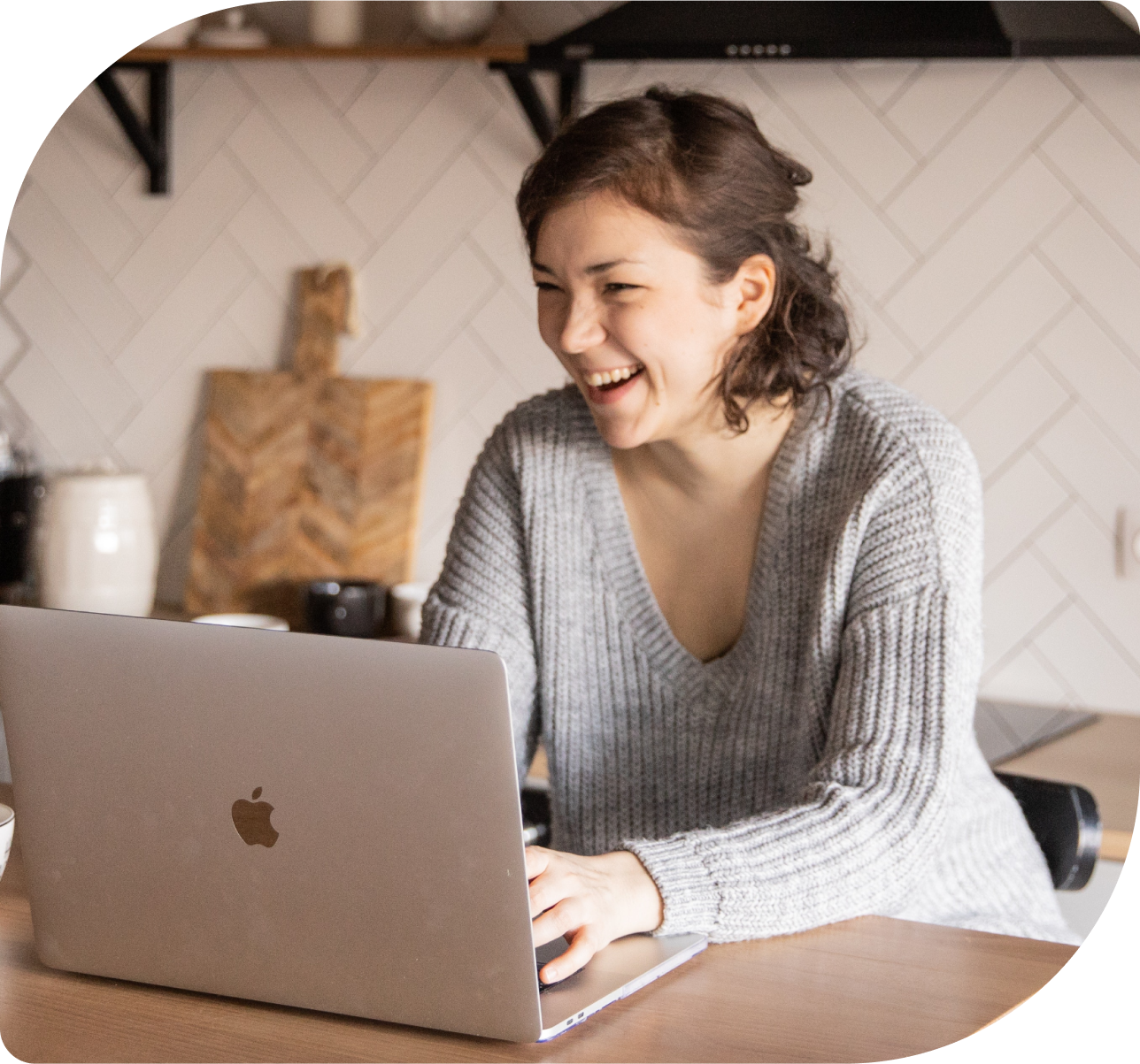 Coach smiling with client on computer