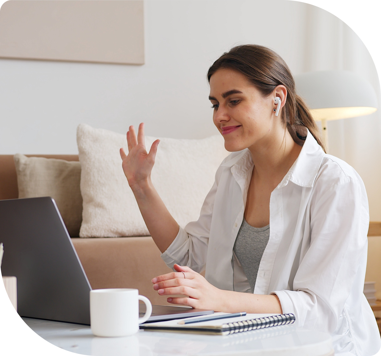Coach waving at client on computer